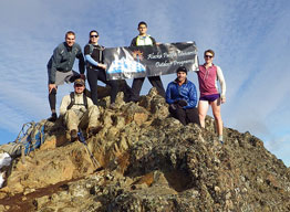 Group of students summiting a mountain climb.