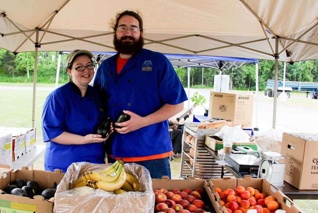 Rachel Carter and Vincent Botzki showcase some of the fresh, organic produce available for purchase.
