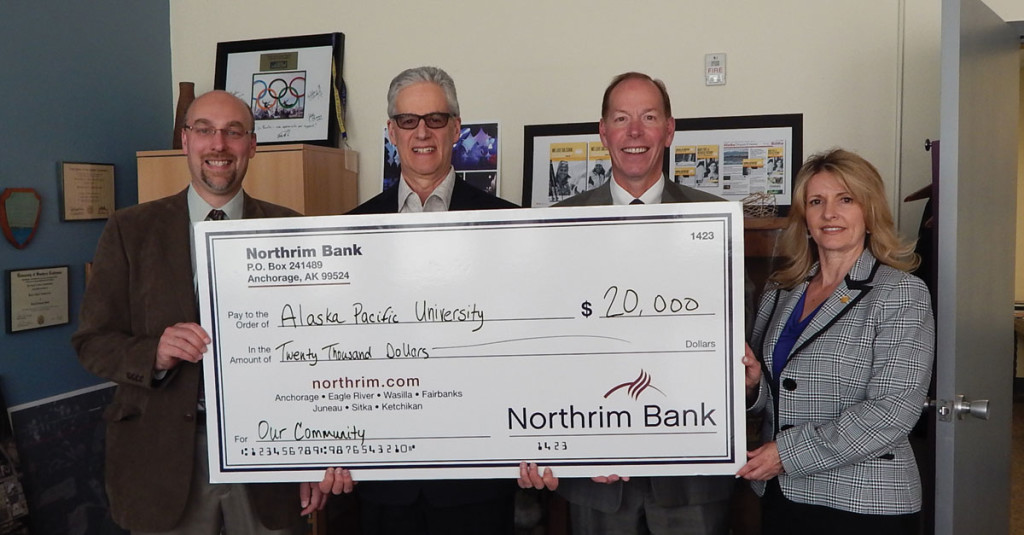 Northrim Bank executives Mark Edwards, Joseph Schierhorn, and Catherine Claxton present the bank's donation of $20,000 to APU President Don Bantz.