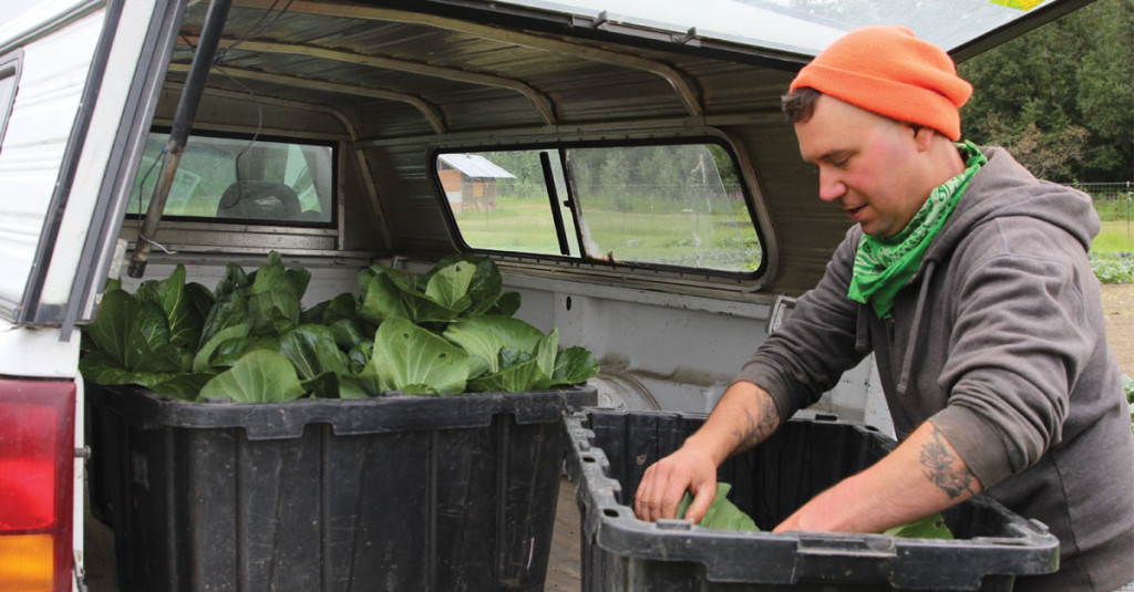 APU’s Spring Creek Farm Production Manager Joshua Faller unloading produce.