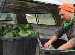 APU’s Spring Creek Farm Production Manager Joshua Faller unloading produce.