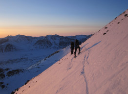 Lars Flora and partner back country skiing as the sun sets.