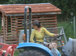 Woman driving tractor at Spring Creek Farm