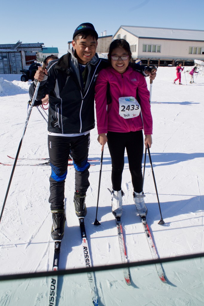 Aaron Tooyak teaching a girl to ski.