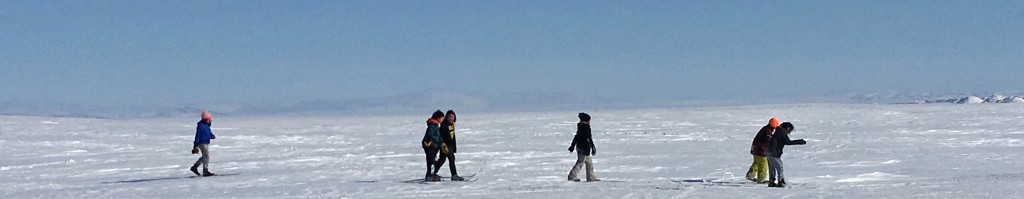 Kids skiing across the ice towards "The Point."