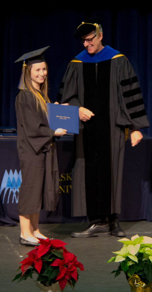 Class of 2016 Fall Graduate receiving her diploma.