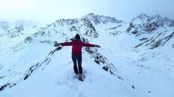 Katie Bishop hiking on a snowy mountaintop.