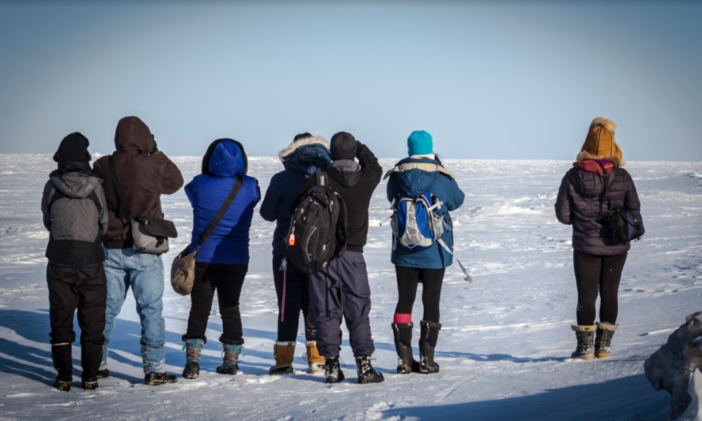 Students overlook the vast Arctic Ocean sea ice. 