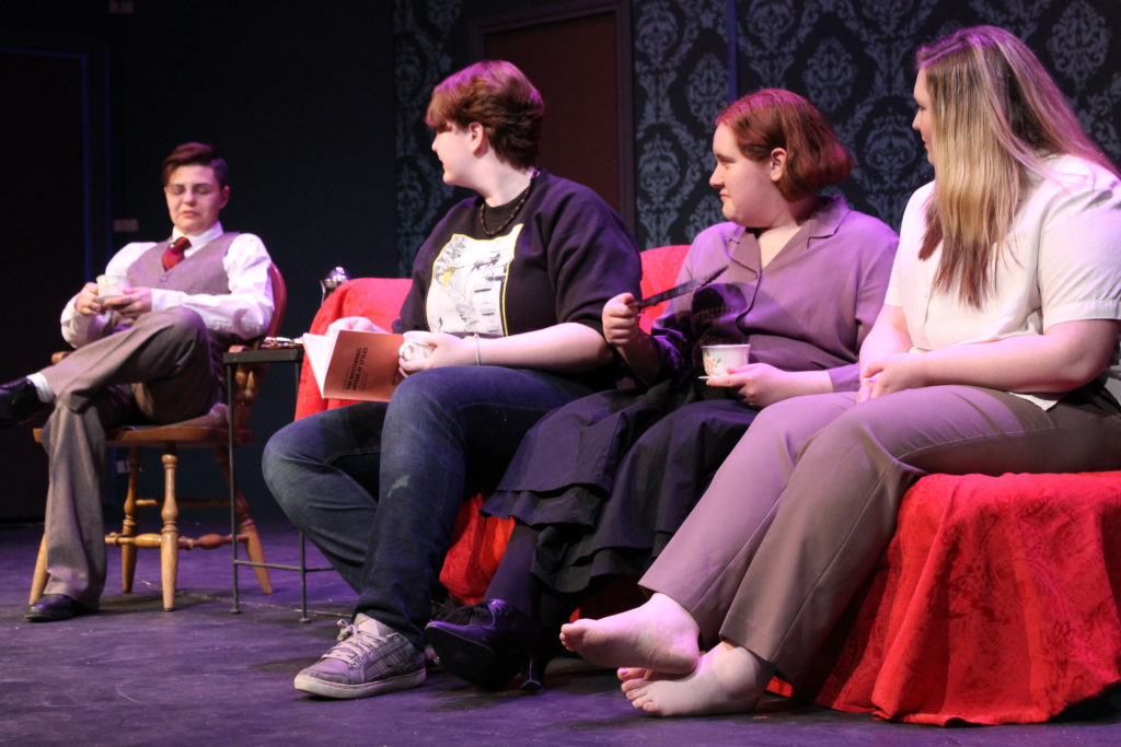 From left to right: Alfred Inglethorp played by Lindsay Serrano, Anika Vojir reading for Captain Arthur Hastings (because he was in class during this rehearsal), Mary Cavendish played by Sarah Cooley and Evelyn Howard played by Zoe Flannery.  This is the scene where Hastings is getting to know the residents of Styles. 