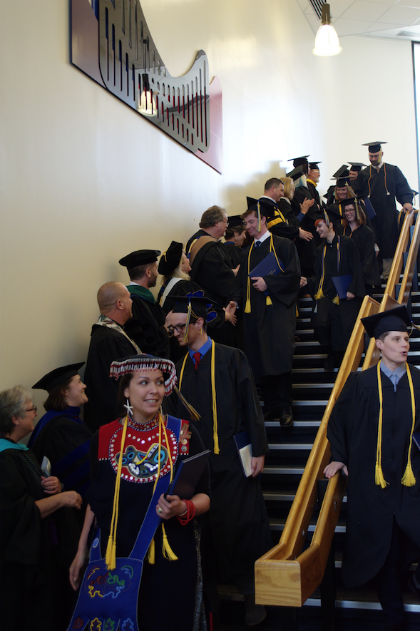Faculty congratulating graduates after Spring 2017 APU Graduation Ceremony