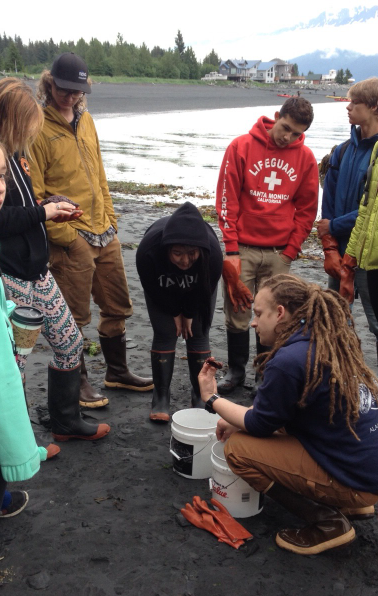 Getting a lesson on sea creatures during low tide with student Ben Jevons.