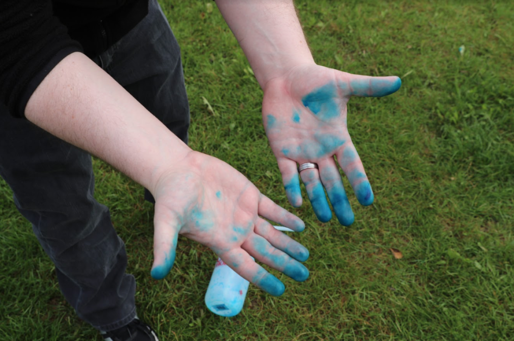 Student with hands dyed blue.