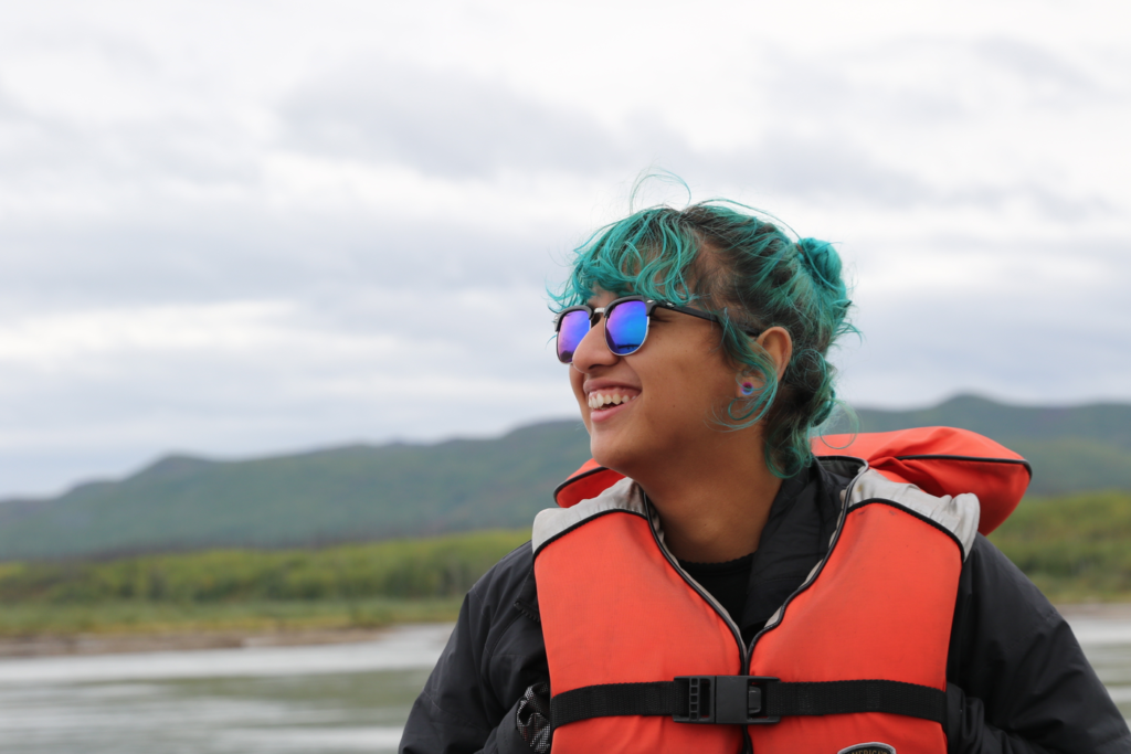 Student with green hair rafting the Yukon River.