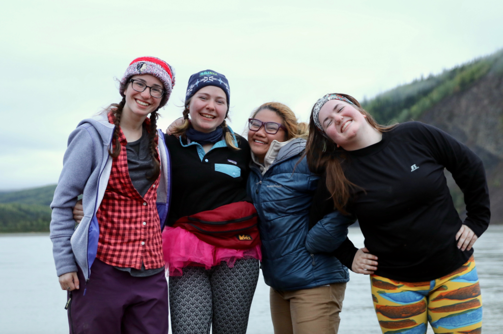 Four happy girls pose along the Yukon River.