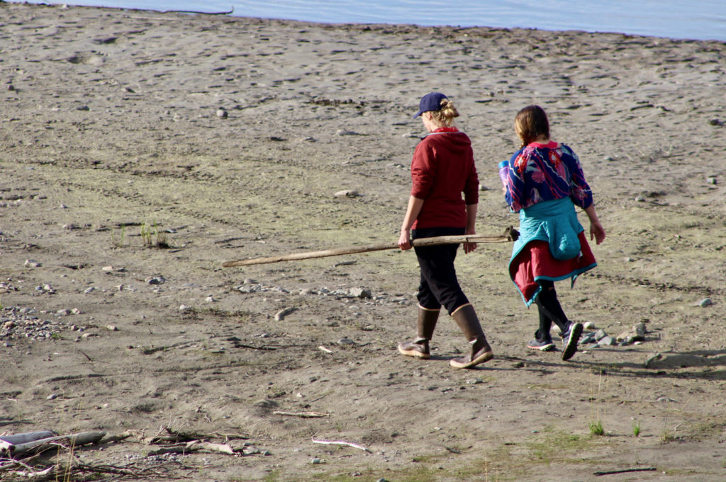 Two students walking along the Yukon River.