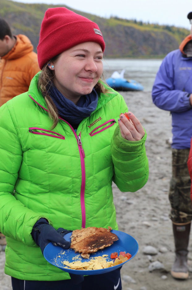 Student takes a break for lunch from rafting the Yukon River.