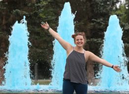 Woman standing by blue fountain - Convocation 2018