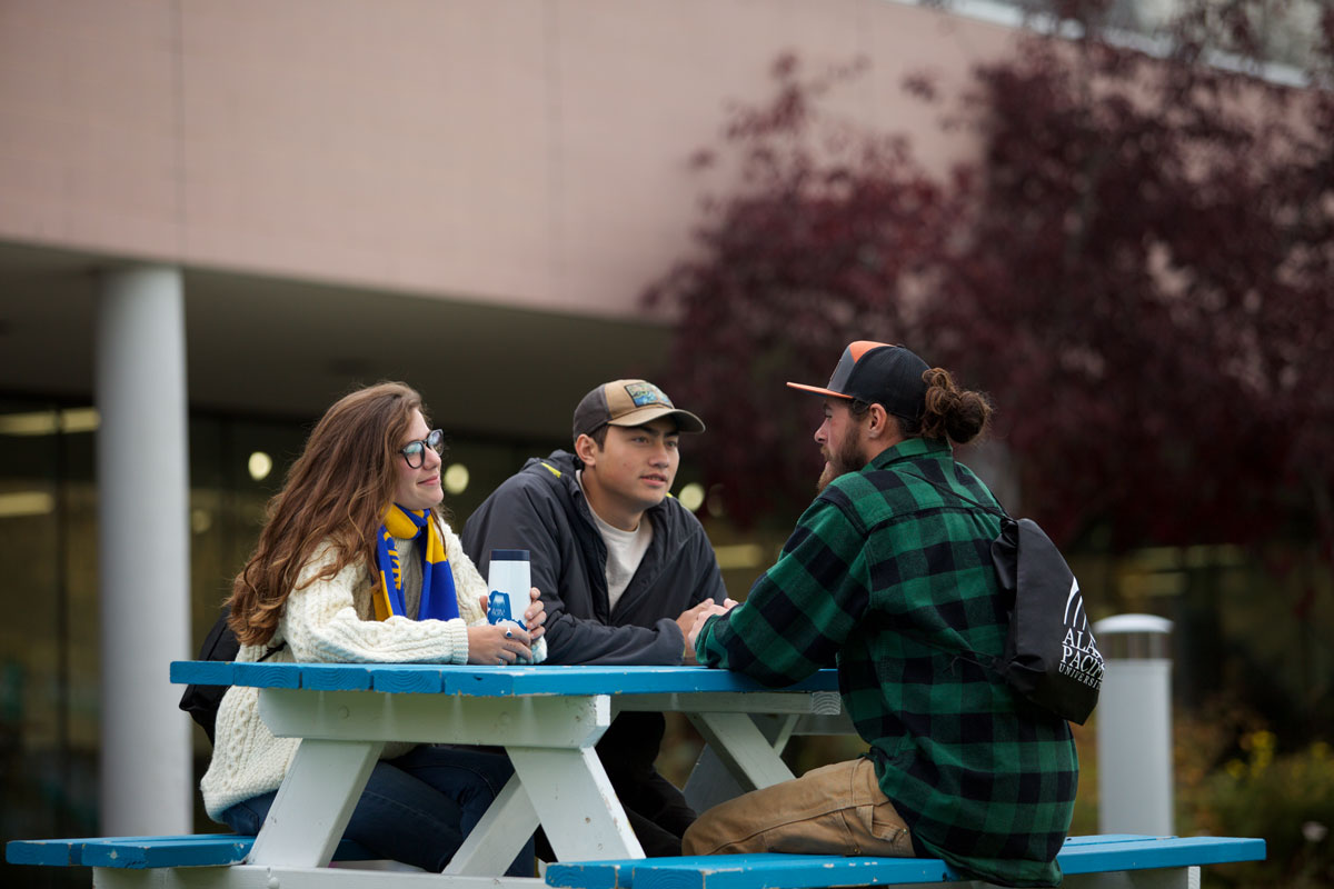 APU Students sitting at a picnic table