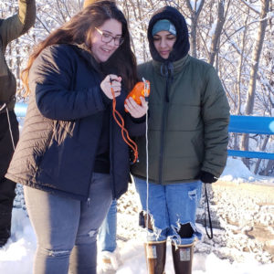 Students drop a CTD sensor into Anchorage’s Westchester Lagoon.