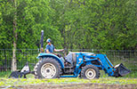 male student on a tractor in a field
