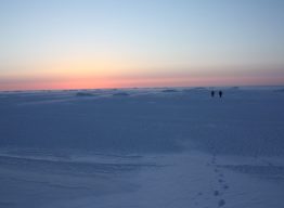 Researchers walk on winter shorefast sea ice in the Chukchi Sea