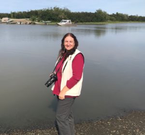 Diane Droutman, Associate Professor of Nursing, standing by the river in Bethel