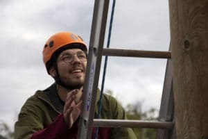 Nolan H. climbs a ladder at Burchell High School's ropes course