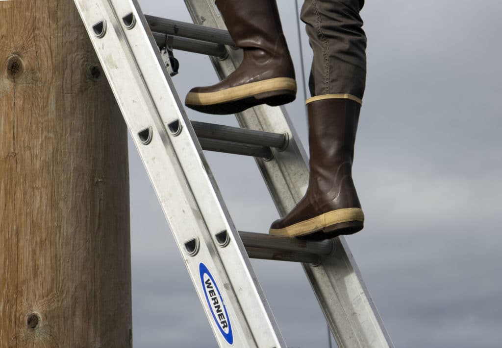 A pair of XtraTuf boots on a ladder at Burchell High School's ropes course