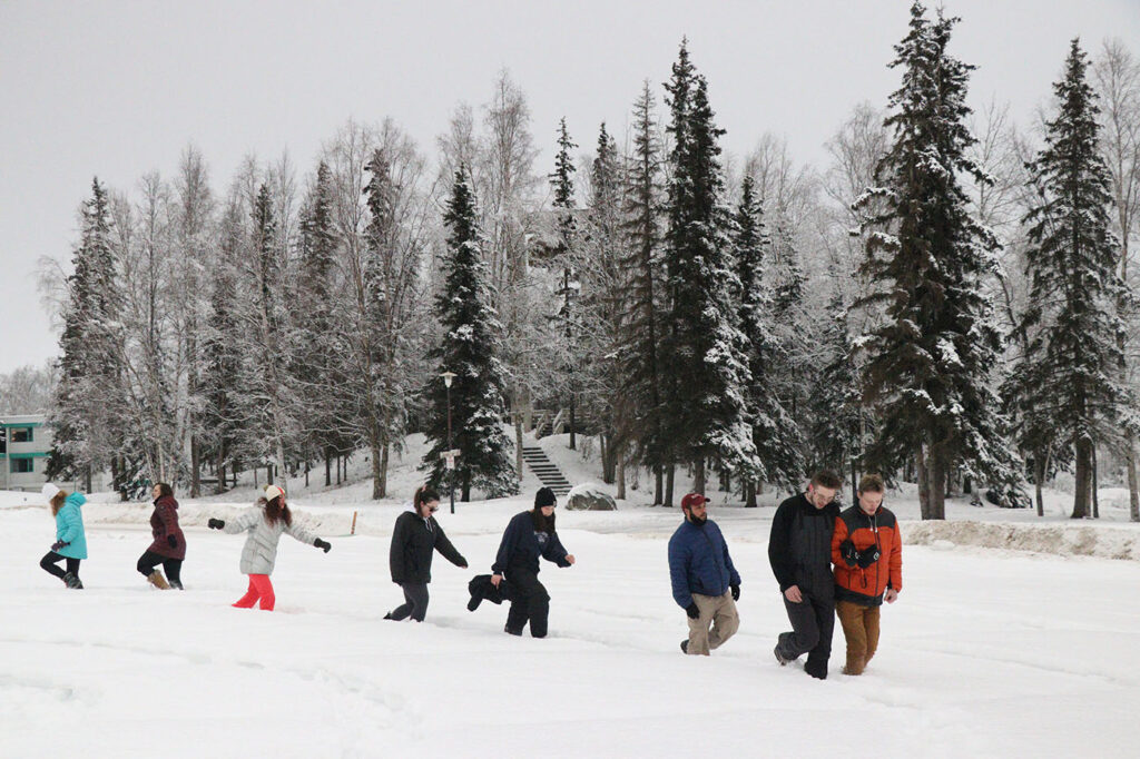 students walking on snow during Psychology Mindfulness Class