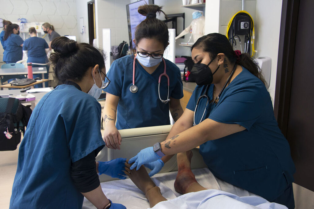 nursing students training with mannequin
