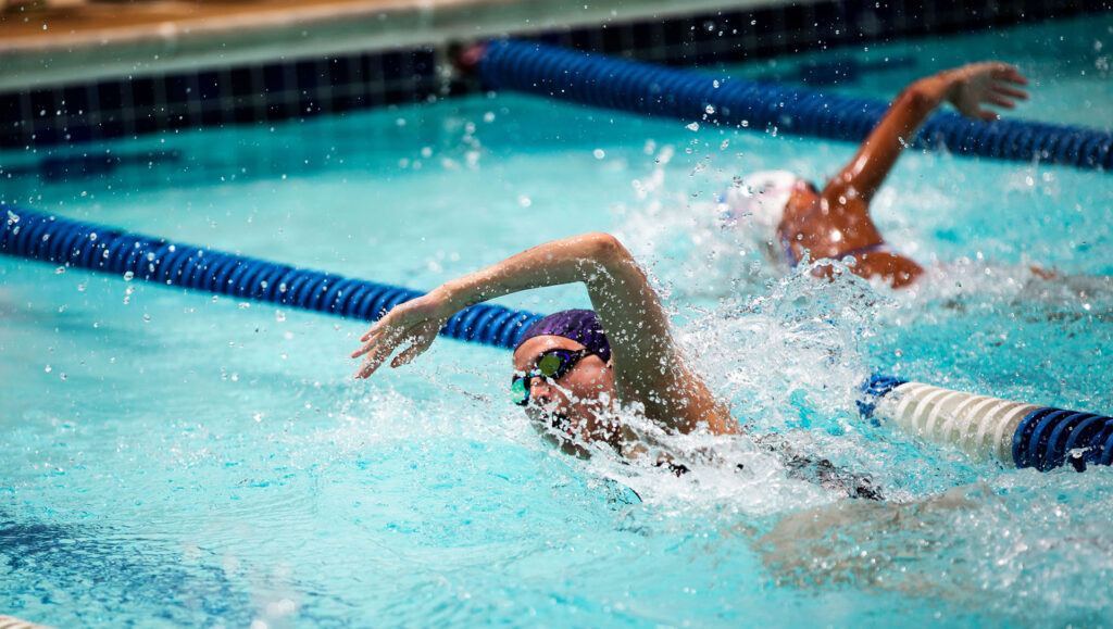 women swimming laps
