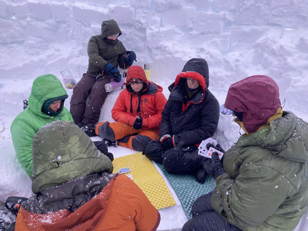students playing cards outdoors in the winter