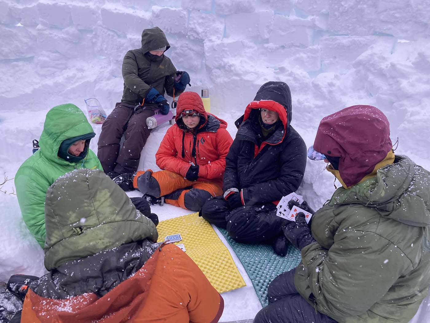 students playing cards outdoors in the winter