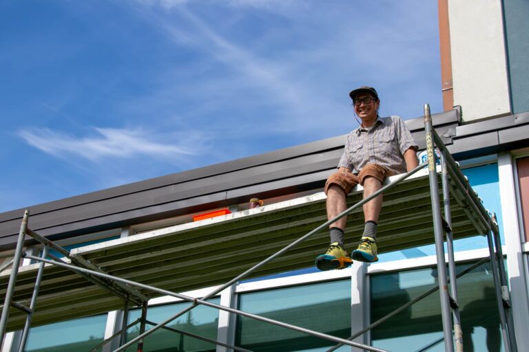 man sitting on scaffolding
