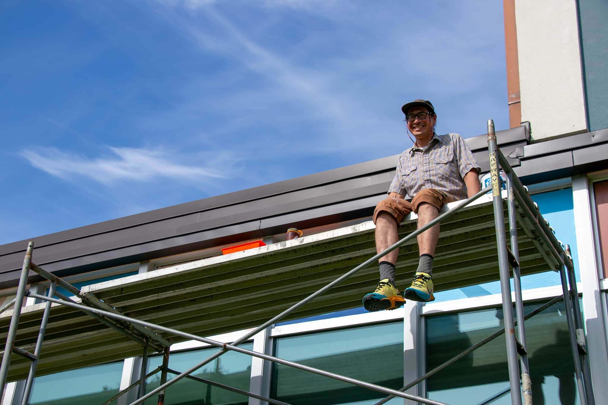 man sitting on scaffolding