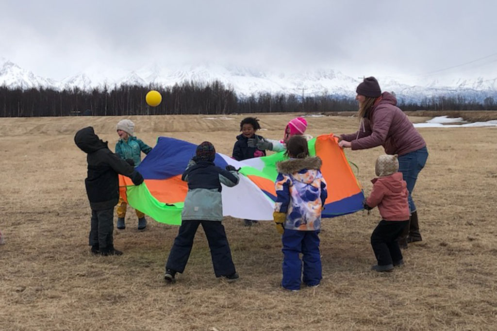 kids playing in the field in the fall