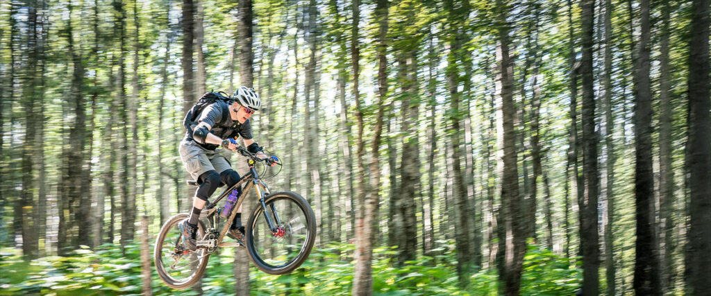 man riding a bike in the woods