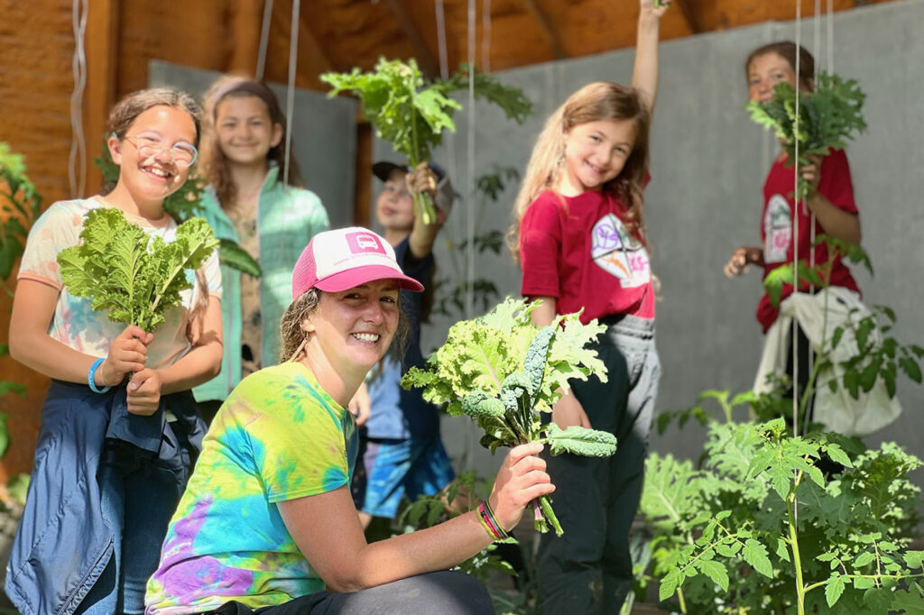 teacher and students holding plants at Kellogg camp
