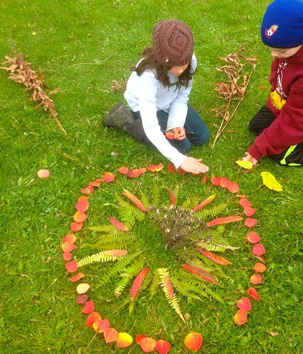 kids playing with leaves in the fall